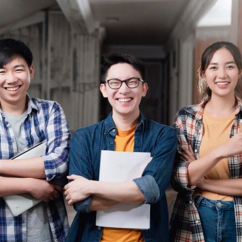 smiling-asian-teamwork-yound-interior-dreative-designer-portrait-stand-together-hand-chest-confident-smart-team-with-background-construction-home-renovate_609648-647